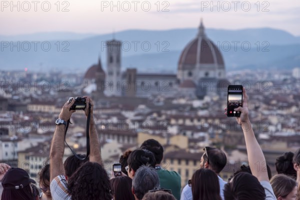 FLORENCE, ITALY, SEPTEMBER 21, 2023, Large tourist crowd on Piazzale Michelangelo enjoying sunset over Florence, Italy, Europe