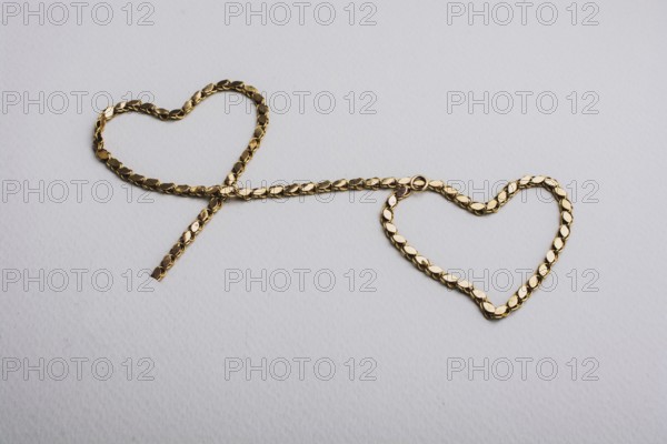 Heart shaped made of gold chain Valentines Day, love, romance concept