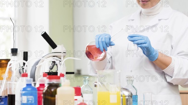 Close up scientist holding flask