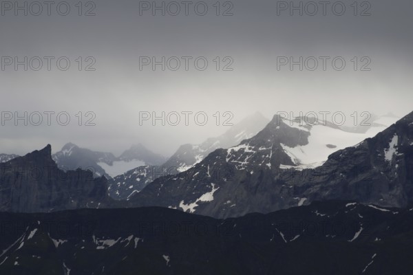 Mountains near of the Grimsel mountain pass, Bernese Oberland. View from Mount Brienzer Rothorn. Rainy, dark day