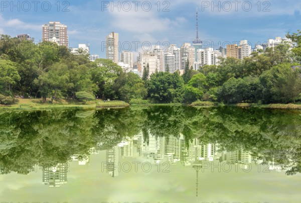 Sao Paulo, Brazil, October 15 2016: The buldings and forest reflection over the lake at the Aclimacao Park in Sao Paulo, South America