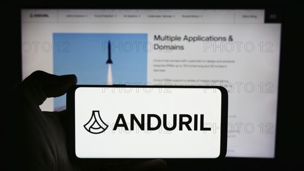 Stuttgart, Germany, 05-21-2024: Person holding cellphone with logo of US defense technology company Anduril Industries Inc. in front of business webpage. Focus on phone display, Europe