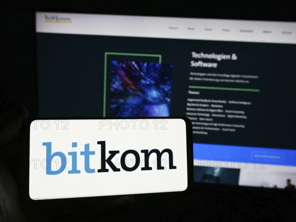 Stuttgart, Germany, 05-07-2024: Person holding smartphone with logo of German telecommunications association Bitkom e. V. in front of website. Focus on phone display, Europe