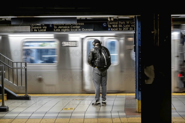 January 16, 2023, New York, NY, USA: Passengers wait for their train on the New York subway system during rush hour