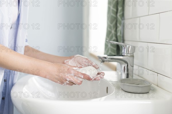 Side view person using bar soap wash their hands