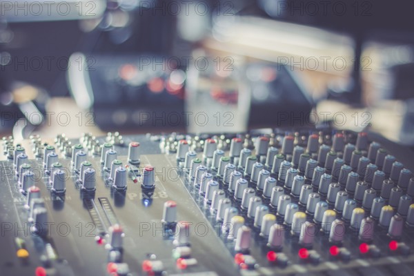 Professional music production in a sound recording studio, mixer desk