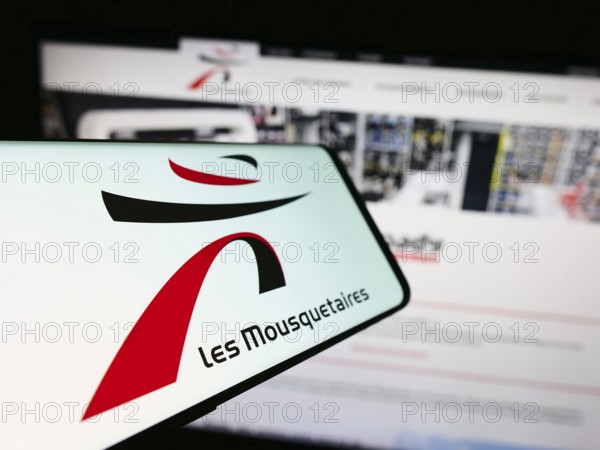 Stuttgart, Germany, 12-08-2023: Smartphone with logo of French company ITM Entreprises S.A. (Les Mousquetaires) in front of website. Focus on center-left of phone display, Europe