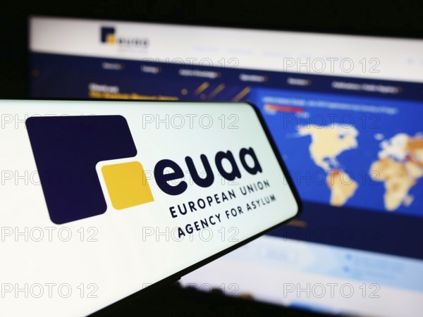 Stuttgart, Germany, 10-17-2023: Smartphone with logo of European Union Agency for Asylum (EUAA) in front of website. Focus on center-left of phone display, Europe