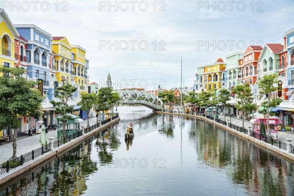 Vibrant buildings and a bridge reflected in a calm river under a clear sky, park, venice copy city, Grand World Phu Quoc, Vietnam, Asia