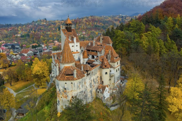 Aerial view of Bran castle in Transylvania region, Romania. Autumn season and dark clouds