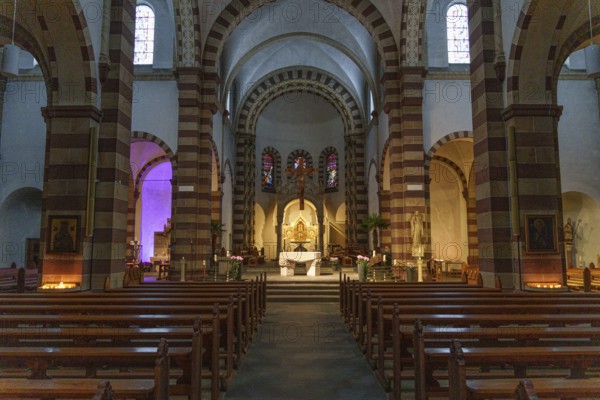 Interior view of an old church with imposing vaults and a central altar, surrounded by pews and stained glass windows, ankum, Lower Saxony, Germany, Europe