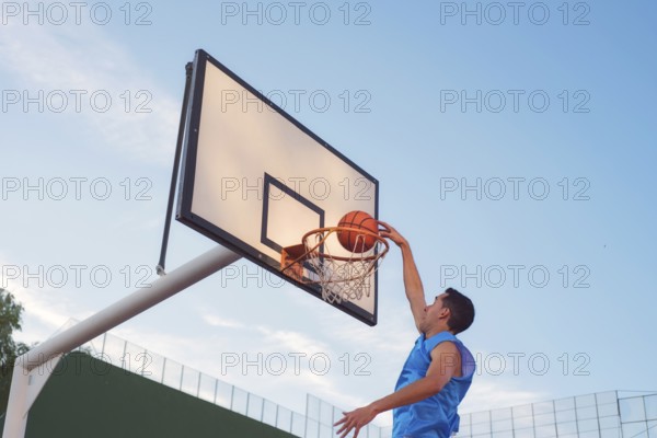 Basketball street player making a slam dunk