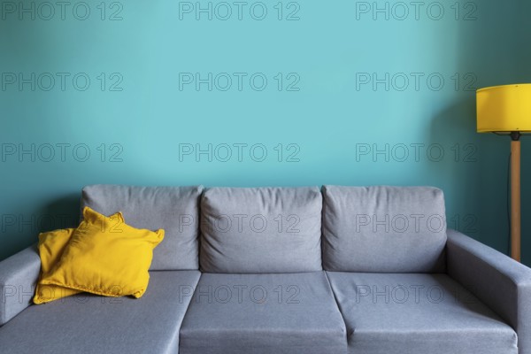 Luxury living room template with modern interior design, turquoise empty wall, gray sofa, yellow lamp and cushions