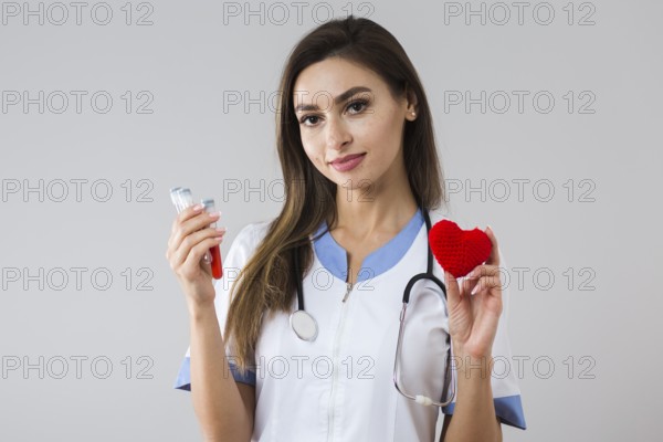 Beautiful woman holding plush heart blood sample