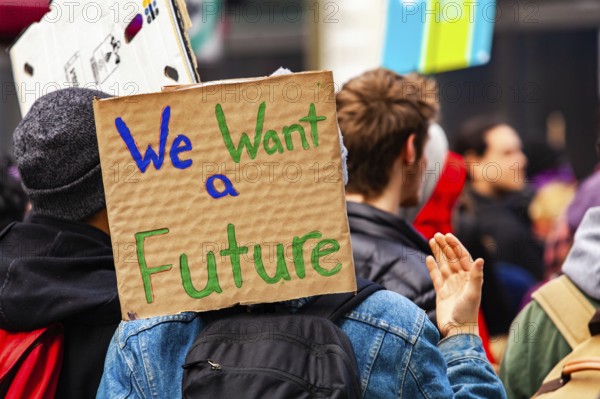 A cardboard sign is viewed close-up saying we want a future as a crowd of environmental campaigners march against climate change in Montreal, Canada, North America