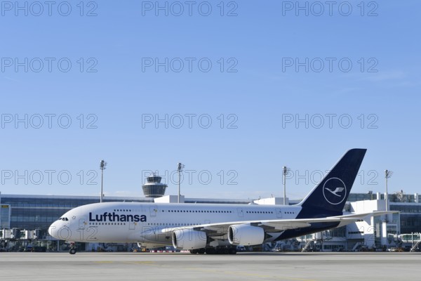 Lufthansa Airbus A380-800 with control tower, taxiing in front of Terminal 2 to runway South Terminal 2, Munich Airport, Upper Bavaria, Bavaria, Germany, Europe