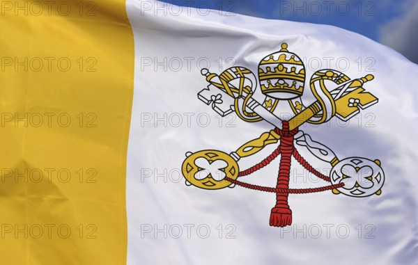 Close-up of the national flag of the Vatican State, fluttering in the wind with folds, wave pattern, tiara, mitre