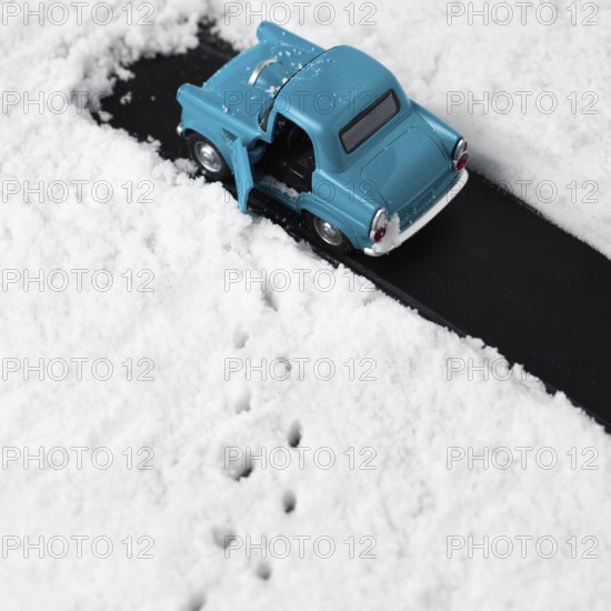 Close up view blue toy car with snow