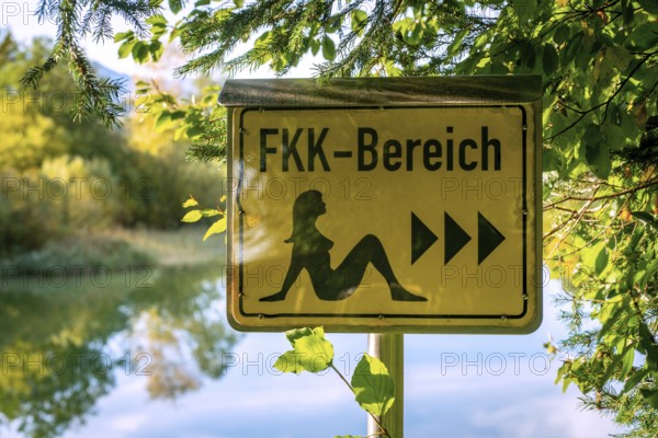German sign board leading the way to the nude swimming area (FKK area) at the beach of lake Bibi (Bibisee) in Bavaria, Germany, Europe