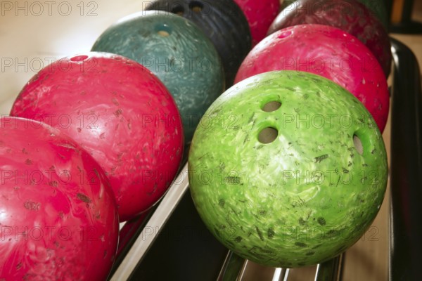 Bowling balls red green closeup row detail