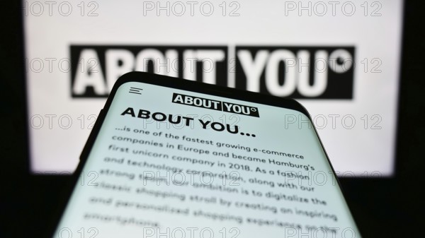 Stuttgart, Germany, 03-14-2023: Smartphone with webpage of German e-commerce company About You SE Co. KG on screen in front of business logo. Focus on top-left of phone display, Europe