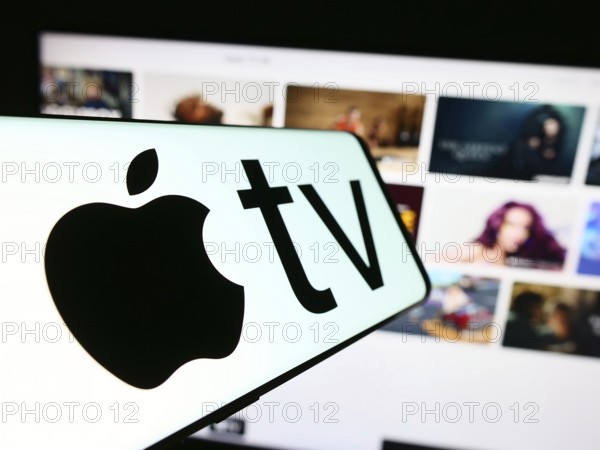 Stuttgart, Germany, 09-23-2023: Smartphone with logo of video streaming service Apple TV plus on screen in front of business website. Focus on center-left of phone display, Europe