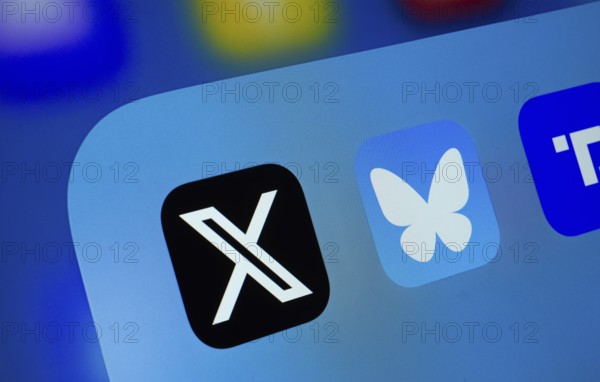 A close up of an iPad screen displaying the X, Bluesky and Truth Social app