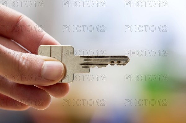 Holding a house key in the hand: New home and property