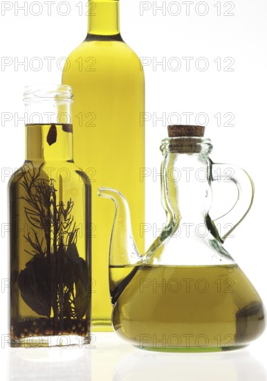 OLIVE OIL, BOTTLES AGAINST WHITE BACKGROUND