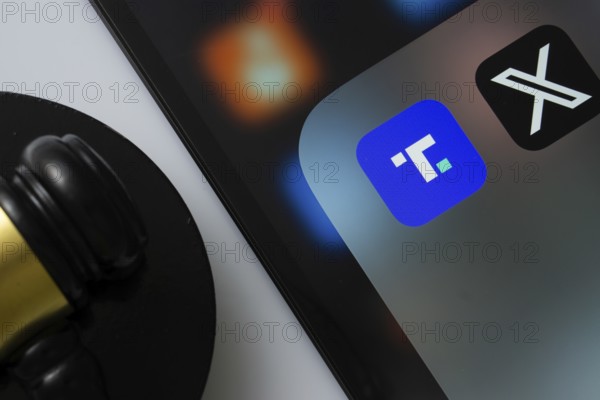 A close up of an iPad screen displaying the Truth Social and Twitter (X) app alongside a judge's gavel