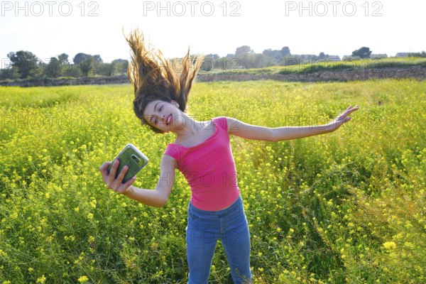 Teen girl selfie video photo in spring meadow moving hair