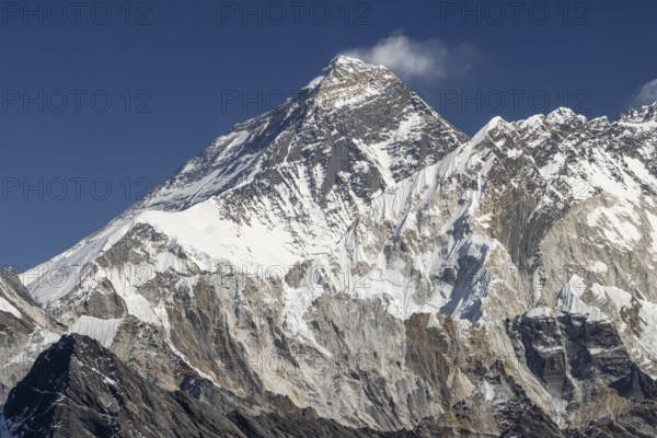 Mount Everest as seen from Renjo La, the mountain pass above Gokyo in Khumbu, the Everest Region. South Summit on the Southeast Ridge, West Ridge, North Face, Southwest Face of Everest can be recognised, and Nuptse is to the right of the highest mountain.Photographed on a clear, blue sky, autumn day. Three Passes Trek, post-monsoon trekking season. Sagarmatha National Park, UNESCO World Heritage Site. Solukhumbu, Koshi Province, Nepal, Asia
