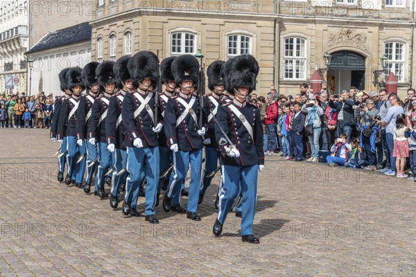 Copenhagen, Denmark, August 12, 2016: Soldiers of the Danish Royal Life Guards for the changing of the guards on the central plaza of Amalienborg palace in Copenhagen. It is the home of the Danish royal family, Europe