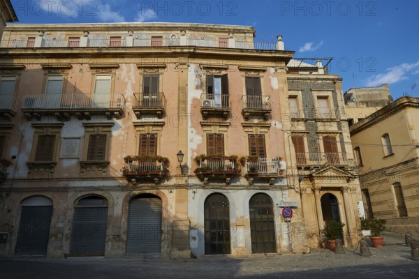 Historic building with worn balconies and shutters on a quiet street, Ortigia Island, Isola di Ortigia, Historic Centre, Syracuse, Sicily, Italy, Europe
