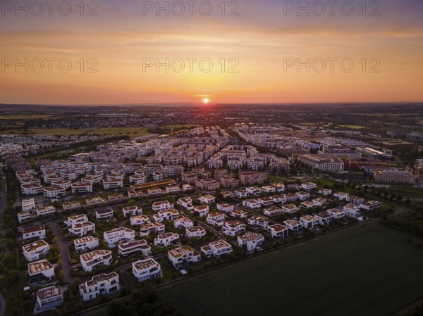 The sun rises behind the Riedberg district of Frankfurt. (Aerial photo with a drone), Germany, Europe