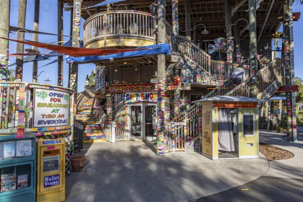 Tacky Jacks bar and restaurant decorated with strips of brightly colored stickers where guests write names or messages in Gulf Shores, Alabama