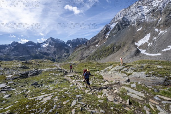 Two mountaineers on a hiking trail through a sunny mountain landscape, ascent to the Kesselkeessattel, Wiener Höhenweg, Schober Group, Hohe Tauern National Park, Carinthia, Austria, Europe