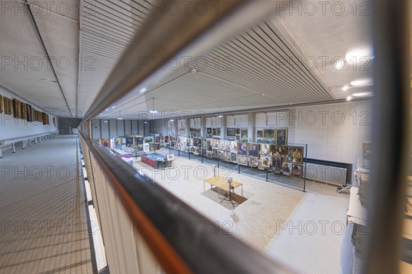 A side view of exhibits in an art gallery illuminated under a textured ceiling, historical art exhibition in the old swimming pool, Schaudepot, Calw, Black Forest, Germany, Europe