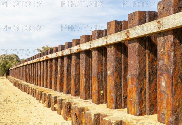 Old rusty steel sheet piling sea wall coastal defence, River Deben, Bawdsey, Suffolk, England, UK