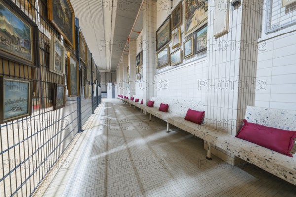Long corridor with paintings on the walls and upholstered benches, historical art exhibition in the old swimming pool, show depot, Calw, Black Forest, Germany, Europe