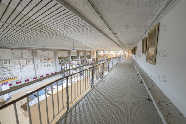 A wide corridor in a gallery with works of art on the walls and modern architectural design, historical art exhibition in the old swimming pool, Schaudepot, Calw, Black Forest, Germany, Europe