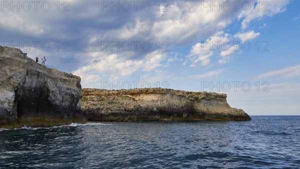 Rocky coast with cloudy sky and blue sea, boat trip around the island of Ortigia, Isola di Ortigia, Syracuse, Sicily, Italy, Europe