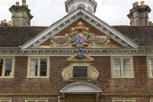 Royal Coat of Arms architectural detail, College of Matrons building, Salisbury, Wiltshire, England, UK 1682