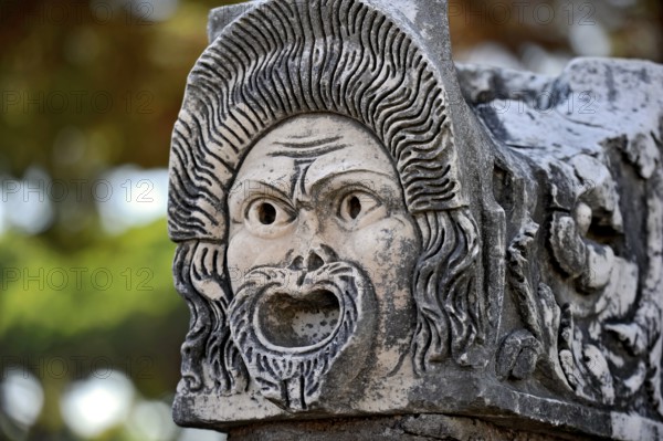 Ancient stone sculpture, stone carving of a mask, Roman theatre, ancient port city of Rome, excavation site Archaeological Park Ostia Antica, metropolitan city of Rome, Lazio, Italy, Europe