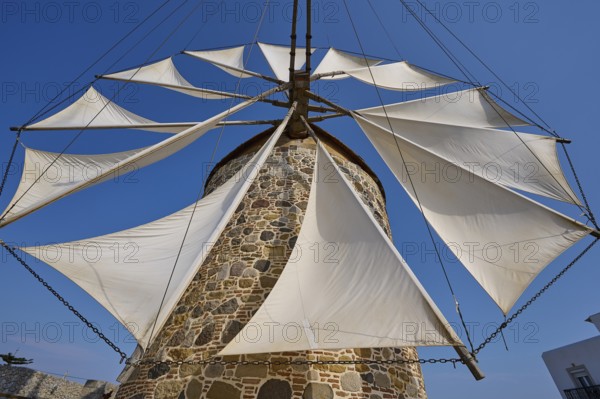 Sails of a stone windmill unfurl under a clear sky, Windmill, Antimacheia, Kos, Dodecanese, Greek Islands, Greece, Europe