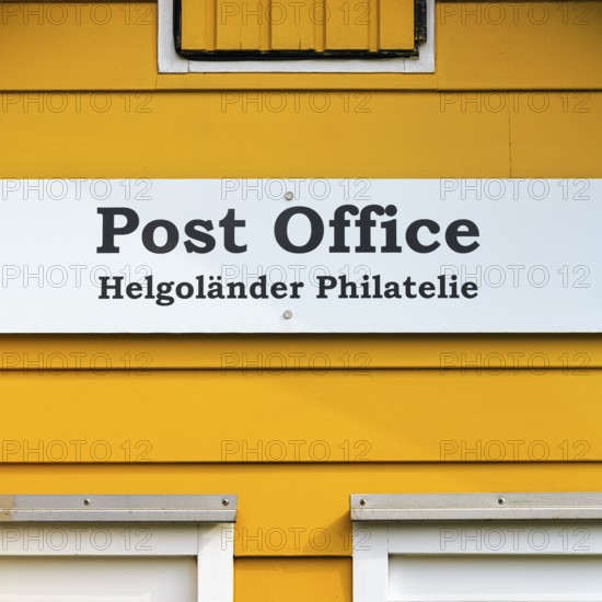 Yellow lobster shack, sign with inscription post office, Helgoland philately, facade detail, Museum Helgoland, Helgoland, Schleswig-Holstein, Germany, Europe