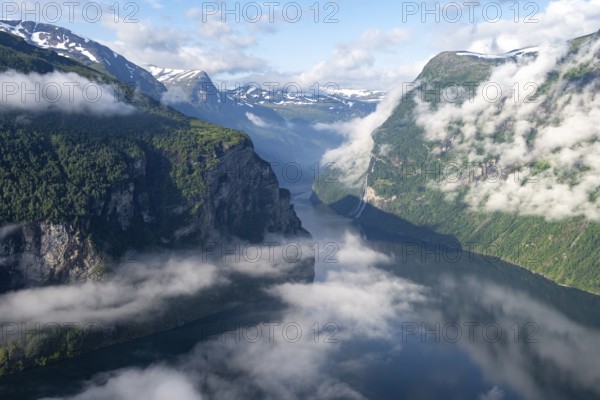 View over the Geirangerfjord, Ørnesvingen viewpoint, atmospheric clouds over the fjord in the morning light, near Geiranger, Møre og Romsdal, Norway, Europe