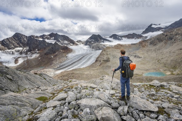 Mountaineer in high mountain landscape, view of the glacier tongue of the Übeltalferner, Stubai Alps, South Tyrol, Italy, Europe