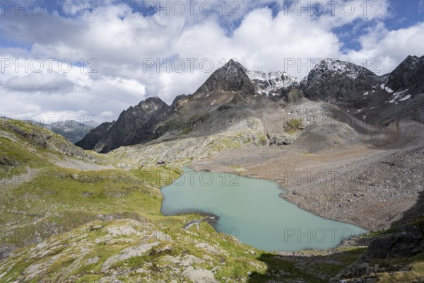 View of the turquoise-blue mountain lake Großer Gradensee, with the peaks of Petzeck and Kruckelkopf behind, Schober Group, Hohe Tauern National Park, Carinthia, Austria, Europe