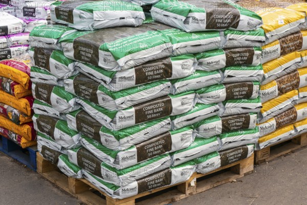 Melcourt composted fine bark bags stacked up at Lowden garden centre, Wiltshire, England, UK